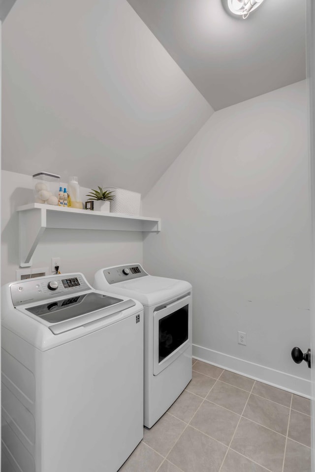 washroom with washer and dryer and light tile patterned flooring