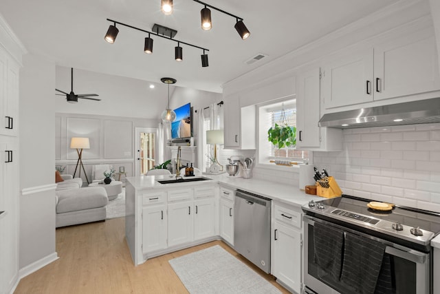 kitchen with visible vents, lofted ceiling, ceiling fan, stainless steel appliances, and under cabinet range hood