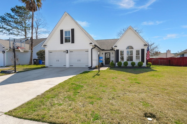 view of front of house with an attached garage, concrete driveway, a front yard, and fence