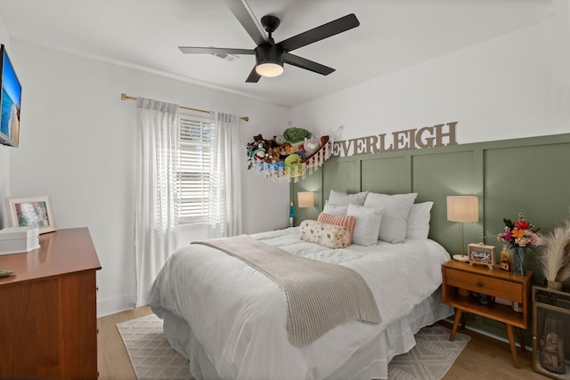 bedroom with a ceiling fan and wood finished floors