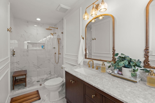 full bathroom with visible vents, toilet, marble finish floor, a marble finish shower, and vanity