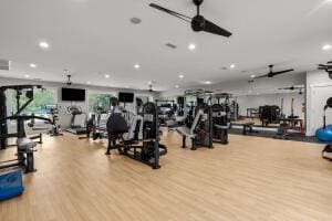 exercise room with recessed lighting and wood finished floors