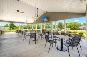 view of patio with outdoor dining area and a ceiling fan