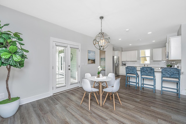 dining room featuring dark wood-style floors, baseboards, a chandelier, and recessed lighting