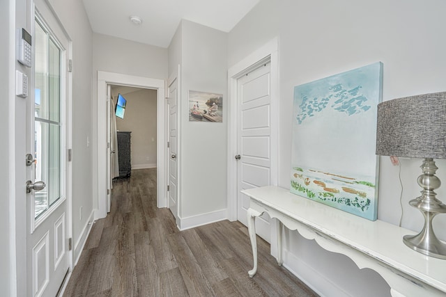 mudroom featuring dark wood-style floors and baseboards