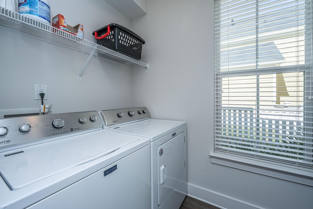 laundry room with laundry area, separate washer and dryer, and baseboards