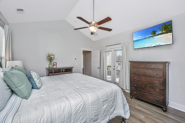 bedroom with baseboards, visible vents, wood finished floors, access to outside, and vaulted ceiling