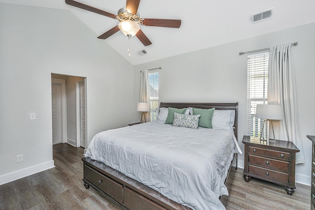 bedroom featuring high vaulted ceiling, wood finished floors, visible vents, and baseboards