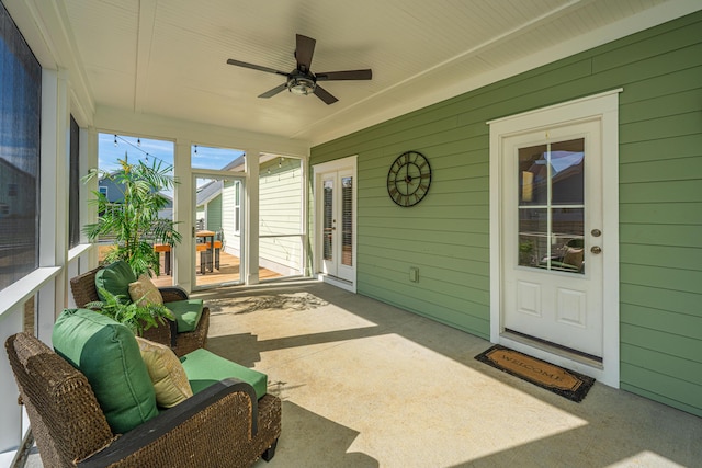 sunroom / solarium with a ceiling fan