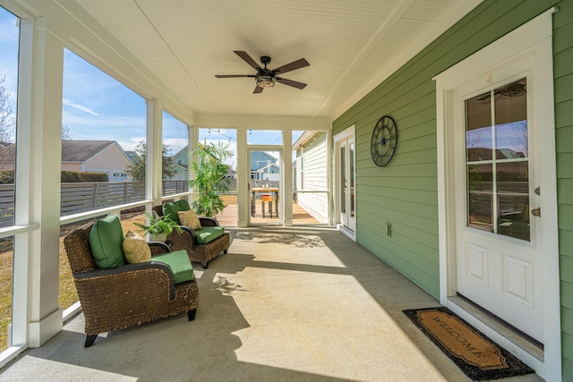 sunroom with ceiling fan and a healthy amount of sunlight