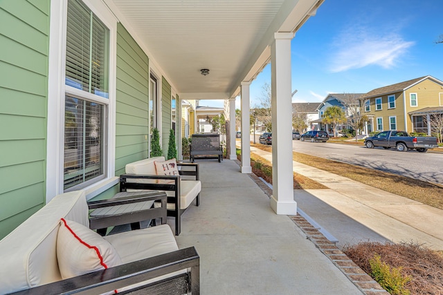 view of patio with a porch, a residential view, and an outdoor living space