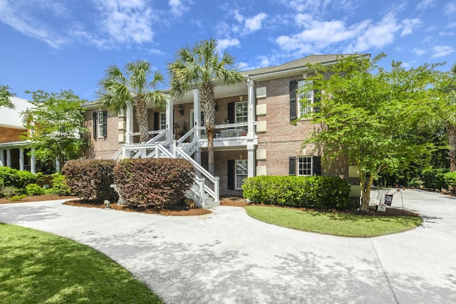 view of building exterior featuring driveway and stairway