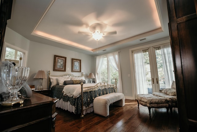2860 Old Drake Dr, Johns Island, SC 29455 - bedroom with a tray ceiling, multiple windows, and dark wood-type flooring