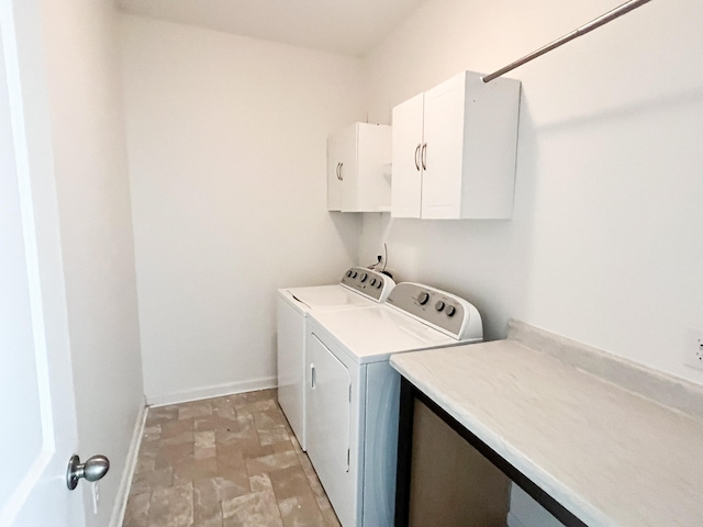 washroom featuring cabinets and separate washer and dryer