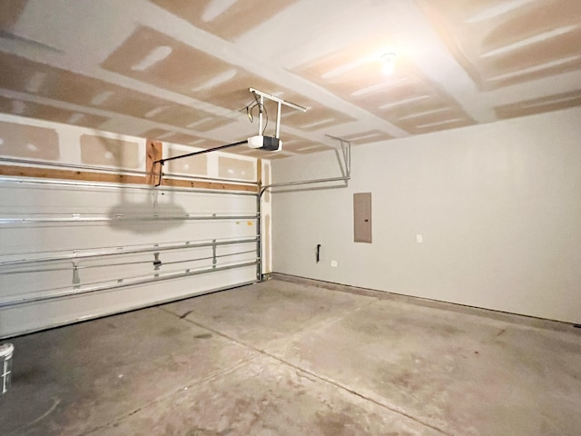 garage with a garage door opener and electric panel