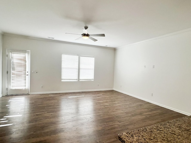 spare room featuring ornamental molding, dark wood-type flooring, and ceiling fan