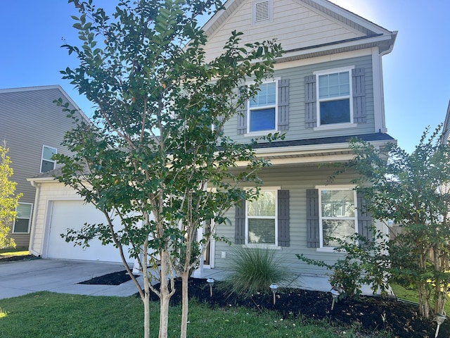 view of front of home with a garage and a front lawn