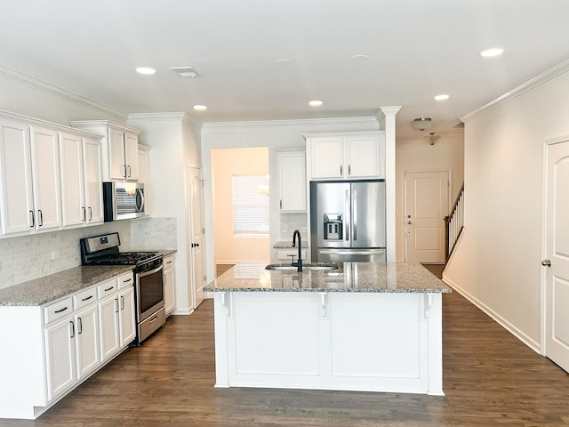 kitchen featuring white cabinetry, stainless steel appliances, and light stone counters