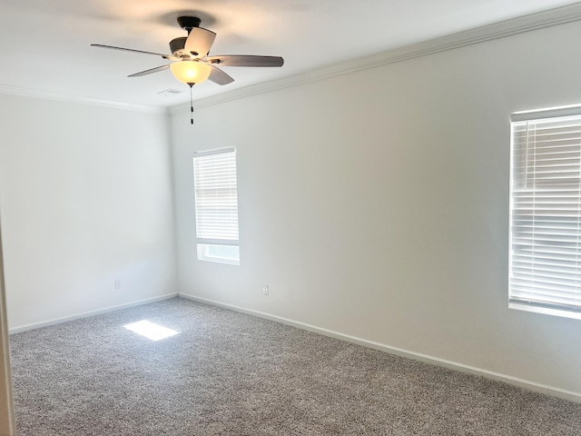 unfurnished room with crown molding, carpet flooring, and ceiling fan