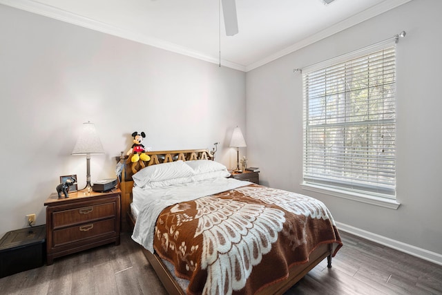 bedroom featuring baseboards, wood finished floors, ornamental molding, and a ceiling fan
