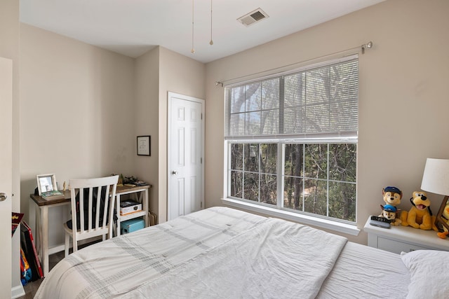 bedroom featuring multiple windows and visible vents