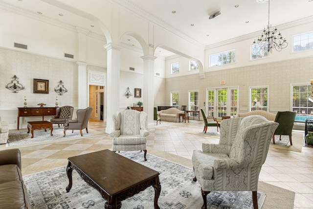 living area with visible vents, ornamental molding, wallpapered walls, and decorative columns
