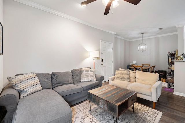 living room with ceiling fan with notable chandelier, crown molding, baseboards, and dark wood-style floors