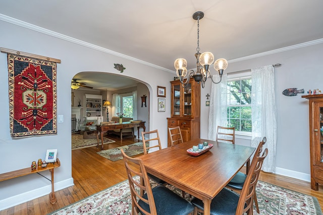 802 Robert E Lee Blvd, Charleston, SC 29412 - dining space featuring arched walkways, a chandelier, hardwood / wood-style floors, ornamental molding, and healthy amount of natural light