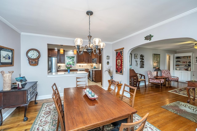 802 Robert E Lee Blvd, Charleston, SC 29412 - dining room with arched walkways, a chandelier, light wood finished floors, ornamental molding, and ceiling fan