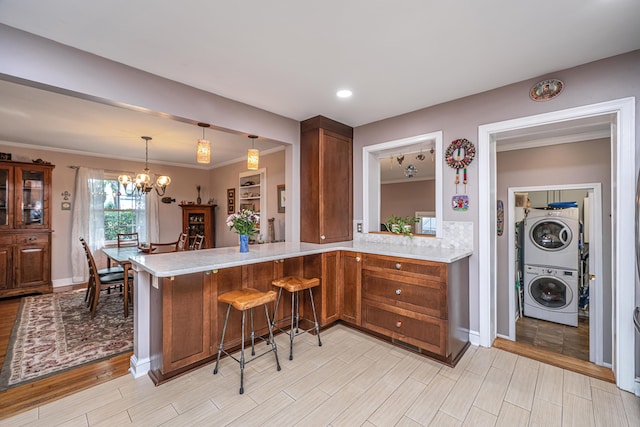 802 Robert E Lee Blvd, Charleston, SC 29412 - kitchen featuring stacked washer / drying machine, light countertops, light wood-style floors, and crown molding