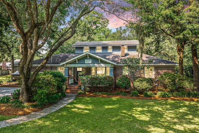 802 Robert E Lee Blvd, Charleston, SC 29412 - view of front of home with a front yard, brick siding, and roof with shingles