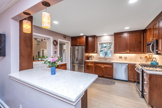 802 Robert E Lee Blvd, Charleston, SC 29412 - kitchen featuring appliances with stainless steel finishes, light countertops, tasteful backsplash, a peninsula, and hanging light fixtures