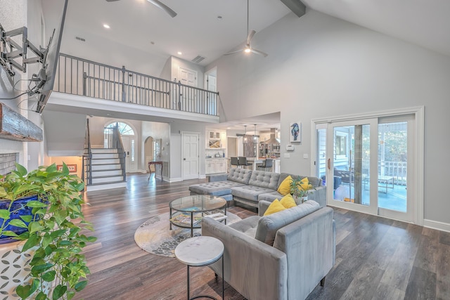 living room with beamed ceiling, dark wood-type flooring, and high vaulted ceiling