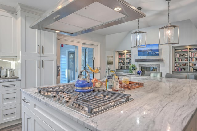 kitchen with white cabinetry, stainless steel gas stovetop, and exhaust hood