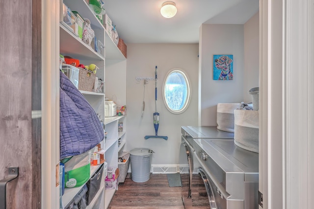 interior space with dark hardwood / wood-style flooring and washing machine and dryer