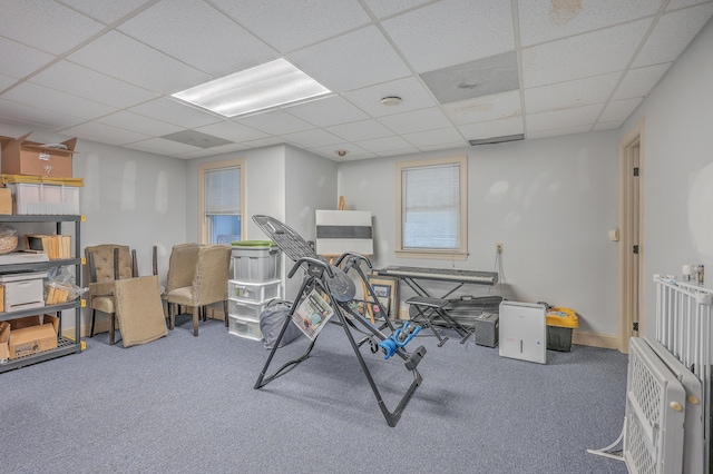 miscellaneous room with a paneled ceiling and carpet floors