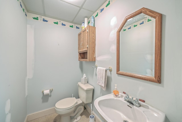 bathroom with tile patterned flooring, sink, and toilet