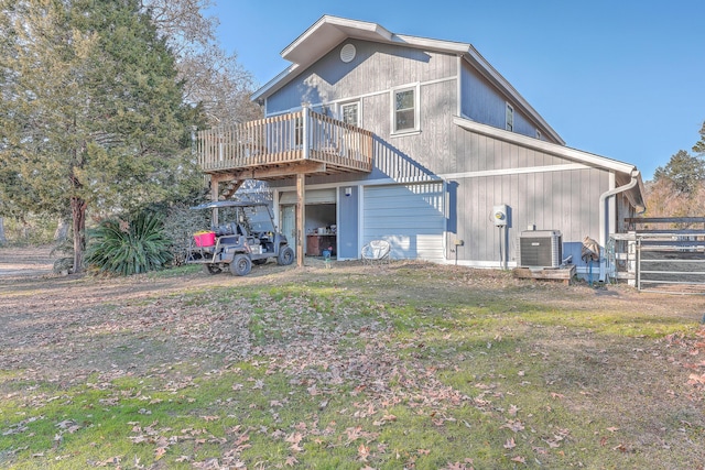 rear view of property featuring a deck and central AC unit