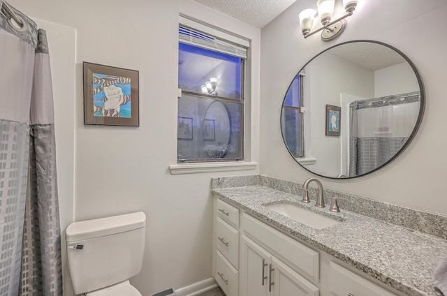 bathroom featuring a shower with curtain, vanity, toilet, and a textured ceiling