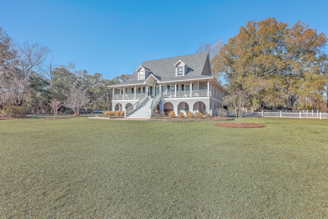 view of front of property with covered porch and a front lawn