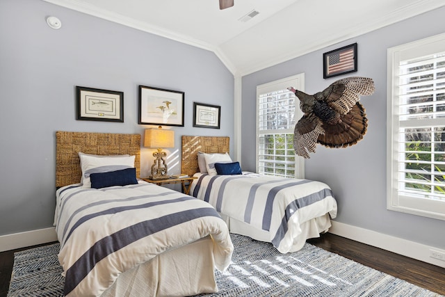 bedroom featuring vaulted ceiling, visible vents, wood finished floors, ornamental molding, and baseboards