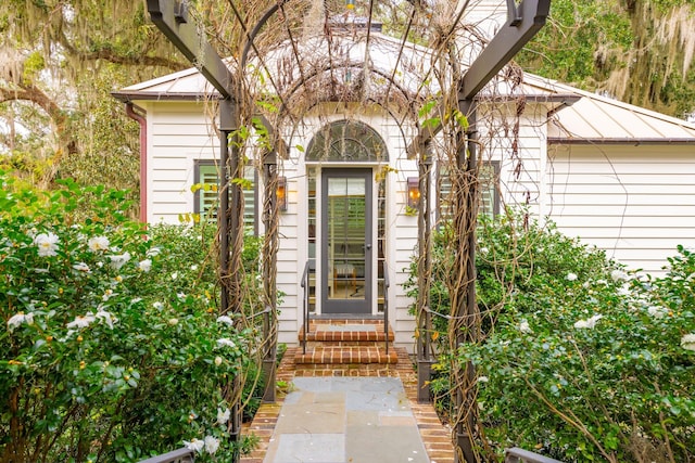 doorway to property with metal roof