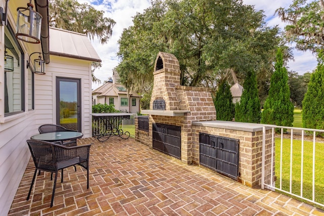 view of patio / terrace featuring an outdoor brick fireplace