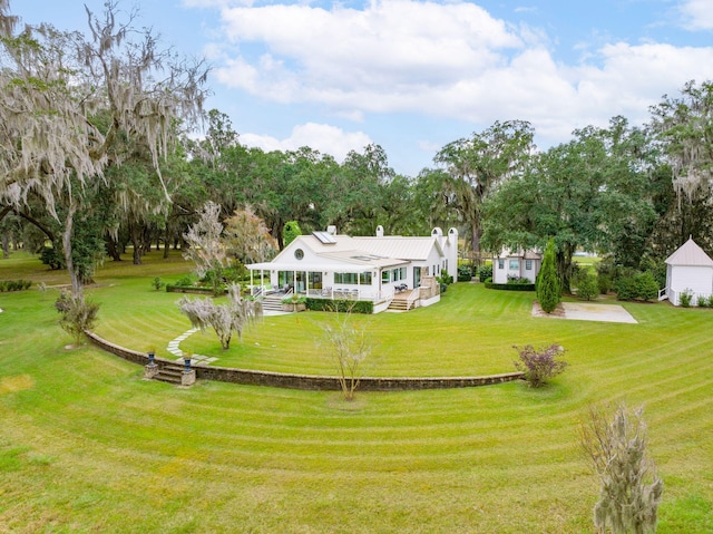 back of property featuring a porch, a chimney, and a yard