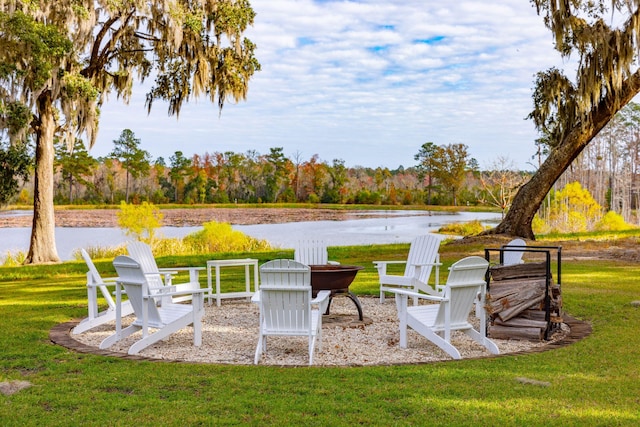 view of yard featuring an outdoor fire pit and a water view