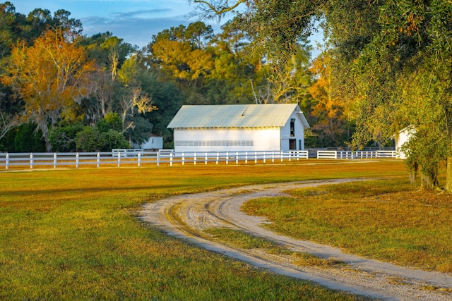 view of property's community featuring fence and a yard