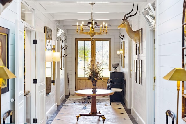entryway featuring beam ceiling and a notable chandelier