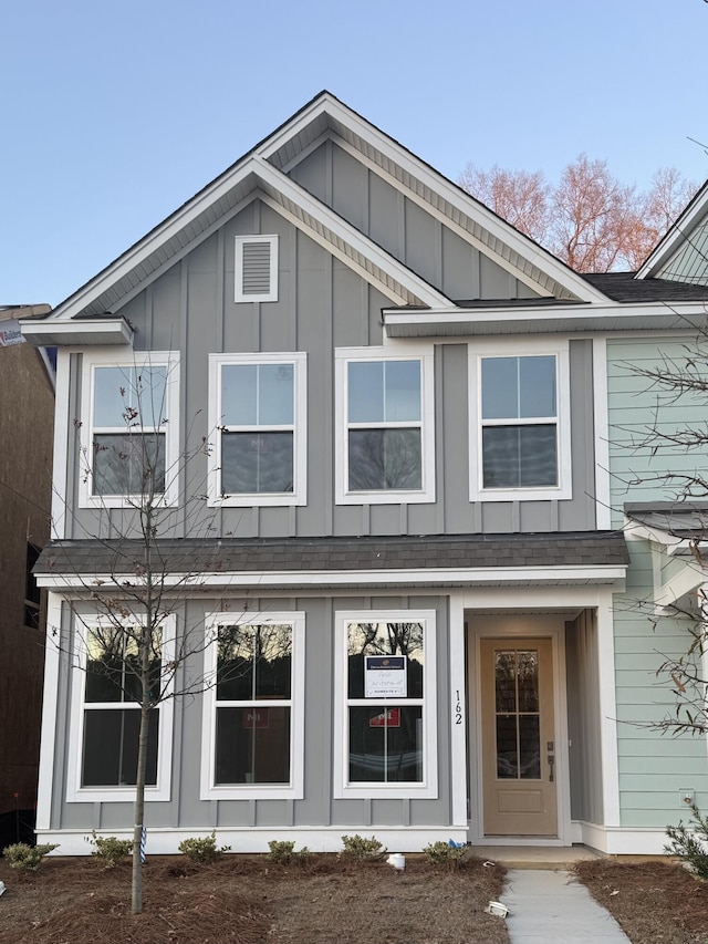 view of front of home featuring a shingled roof and board and batten siding