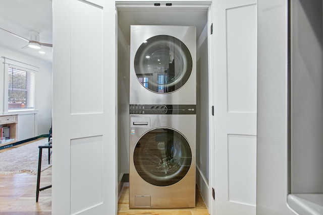 laundry area featuring light hardwood / wood-style floors and stacked washer and dryer