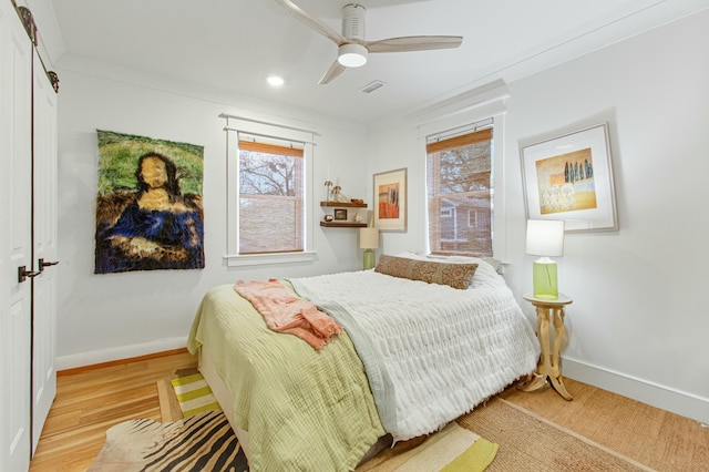 bedroom featuring ceiling fan, light hardwood / wood-style floors, and ornamental molding